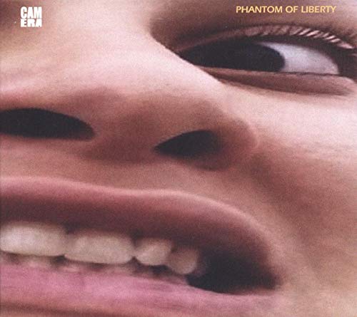 Close-up of a person’s face with distorted features, album cover art.