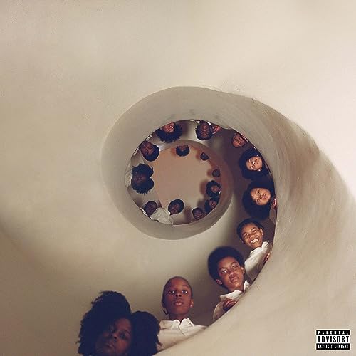 Group of children looking down from a circular stairwell.