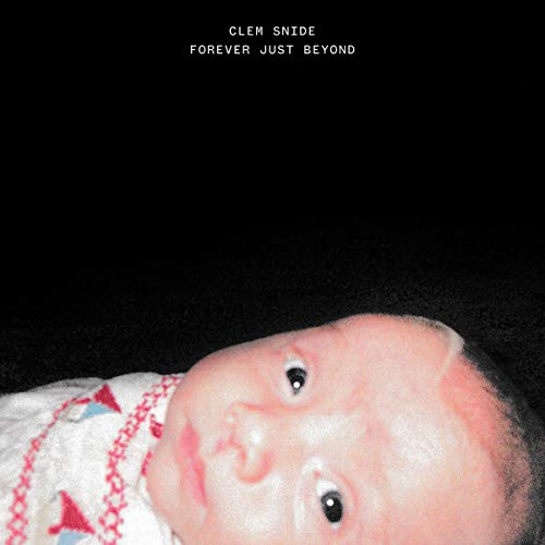 CD cover: black background with a close-up of a baby’s face.