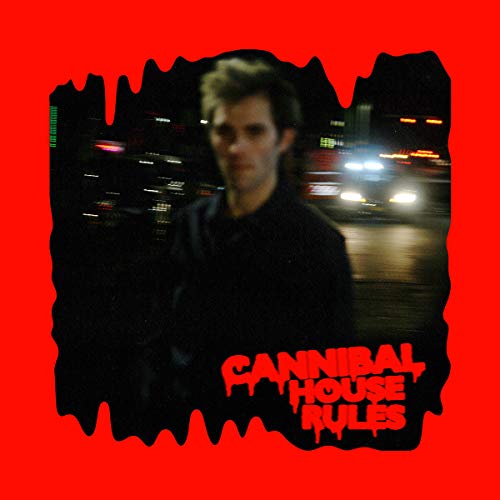 Blurred portrait of a man against a night cityscape, red background.