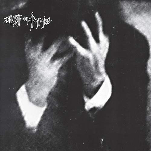 Black and white album cover with obscured face and reaching hands.