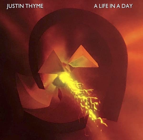Album cover: abstract face with geometric shapes and fiery colors.