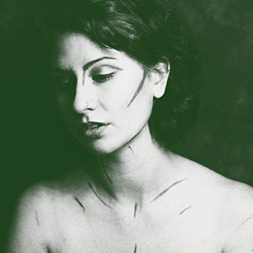 Close-up portrait of Sammi Lanzetta with dark lines on her skin.