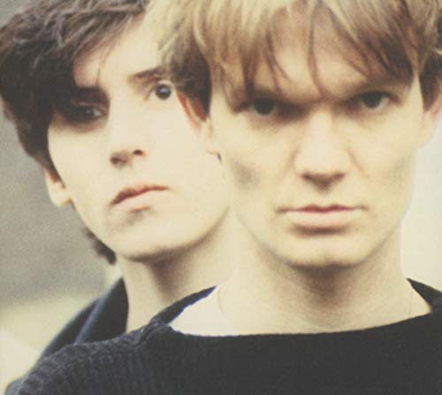 Close-up portrait of two men with dark hair looking directly at the camera.