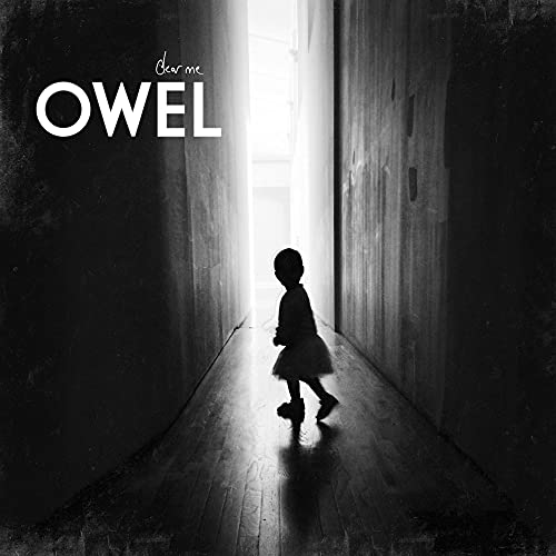 Black and white album cover with a child walking down a hallway.