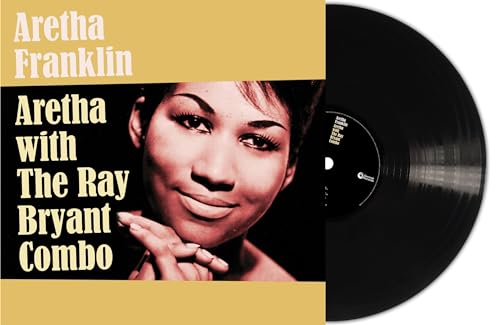 Aretha Franklin album cover with vinyl record, portrait of a smiling woman.