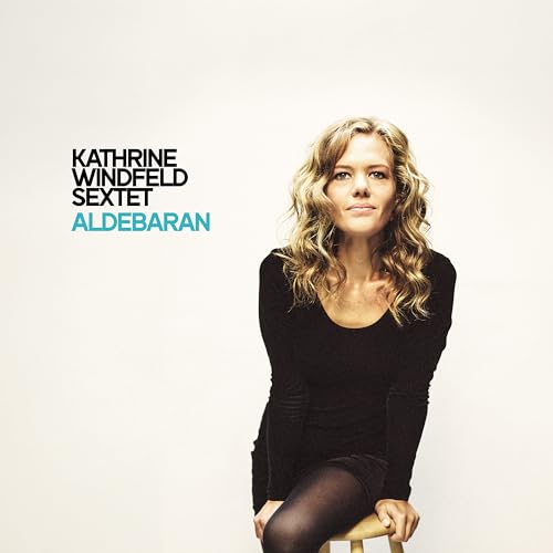 Album cover featuring a woman with wavy blonde hair in a black dress.