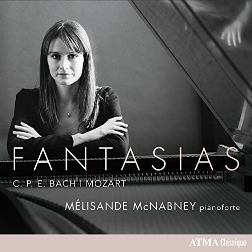 Black and white portrait of Mélisande Mcnabney with piano and album title.