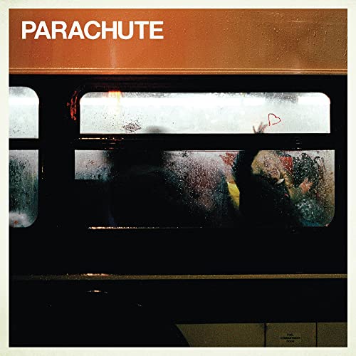 CD cover with a blurry image of people on a train.