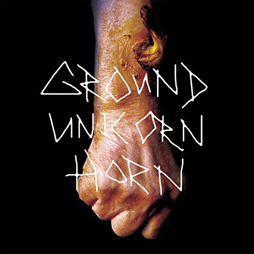 Close-up of a hand with text "Ground Unicorn Horn" overlaid on black.