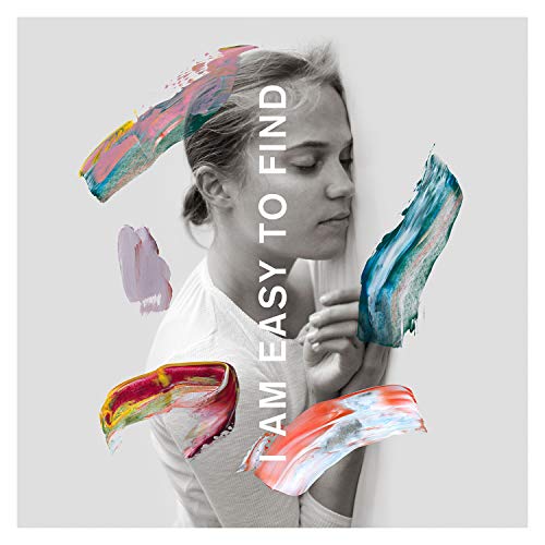 Woman’s face with colorful paint strokes and text “I AM EASY TO FIND”.