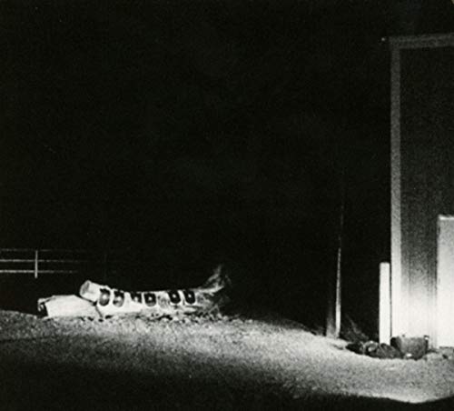 Black and white photo of a building exterior at night.