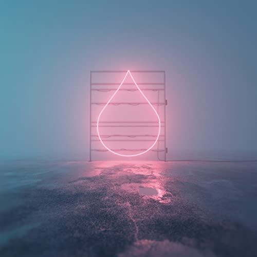 Neon pink teardrop shape within a rectangular frame on a foggy floor.