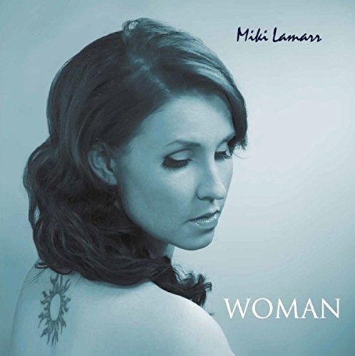 Blue-toned portrait of a woman with short dark hair and a back tattoo.