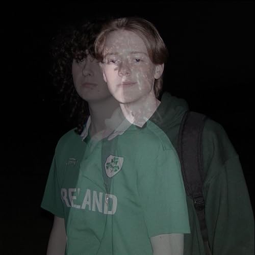 Two young men with shadowed faces, one wearing a green Ireland jersey.