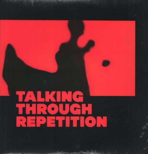 Red and black album cover with silhouetted figure and text.
