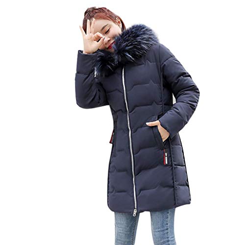 Woman wearing a long, dark puffer jacket with a fur-lined hood.