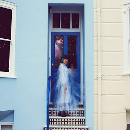 CD cover: Woman in white dress standing in a blue doorway.