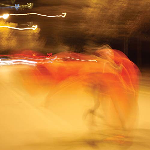 Blurred, abstract image of orange and yellow with light streaks.