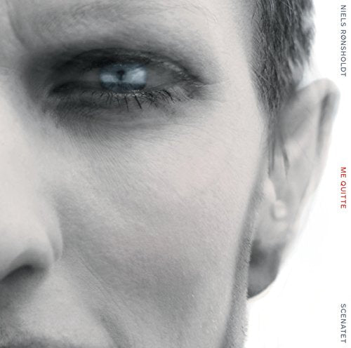 Close-up of a man’s eye with album title “Me Quitte” in red text.