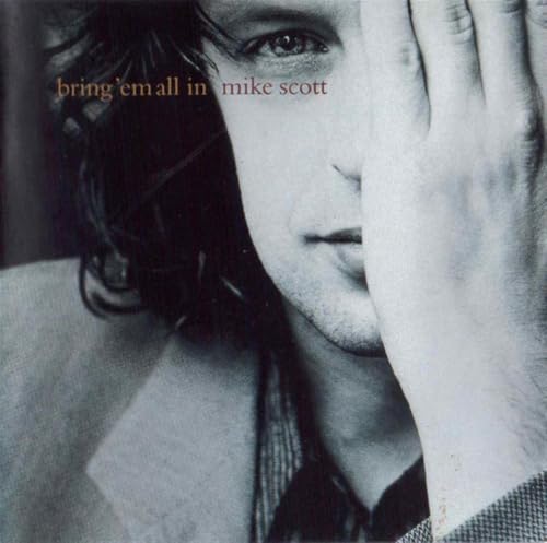 Close-up of Mike Scott’s face, partially obscured, on album cover.