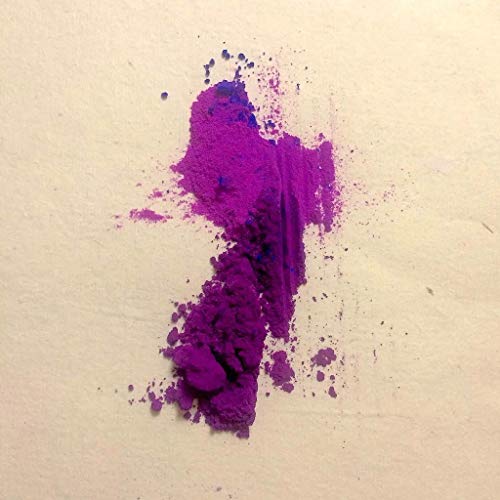 Pile of vibrant purple and blue powder on a light surface.