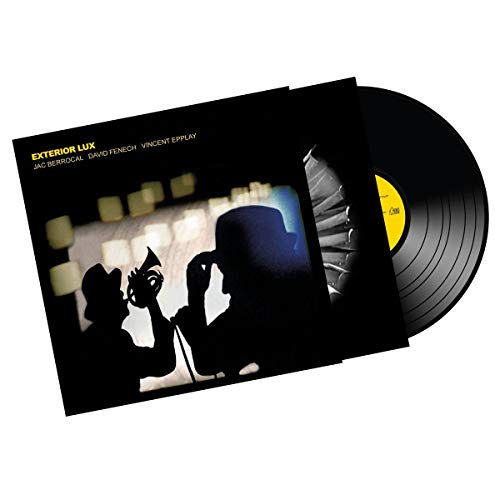 Vinyl record with black cover featuring silhouetted figures and yellow text.