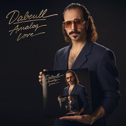 Man in suit holding “Analog Love” CD case with his image on it.