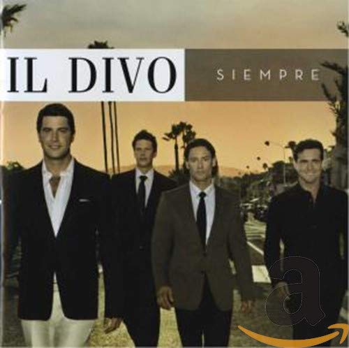 Four men in suits stand in a row against a sunset street background.