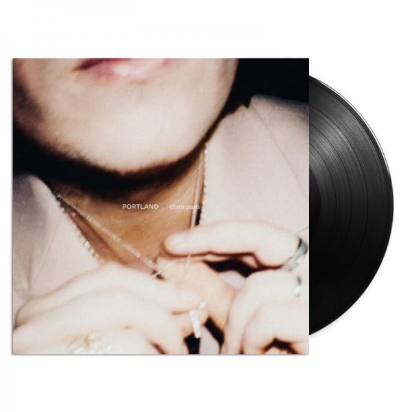 Vinyl record with album cover featuring a close-up portrait and hands.