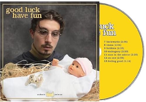 Bbno$ album cover: man with baby doll in hay, yellow CD visible.