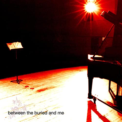 Dark red image of a grand piano and music stand under a bright light.