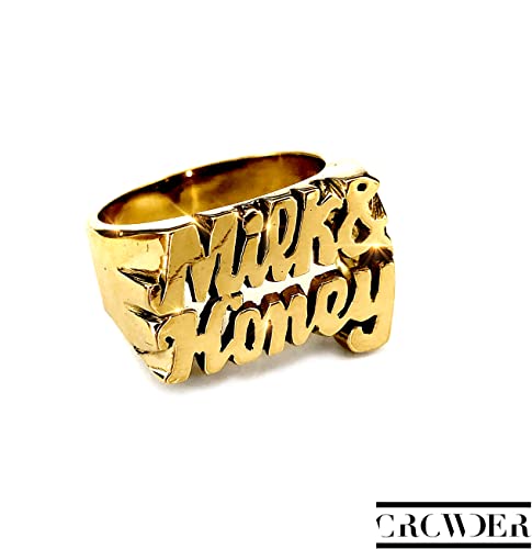 Gold ring with the words Milk & Honey in raised lettering against white background.