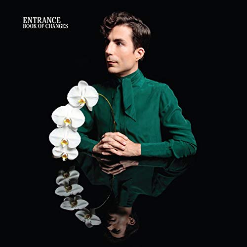 CD cover: Man in green shirt with white orchids, mirrored image.