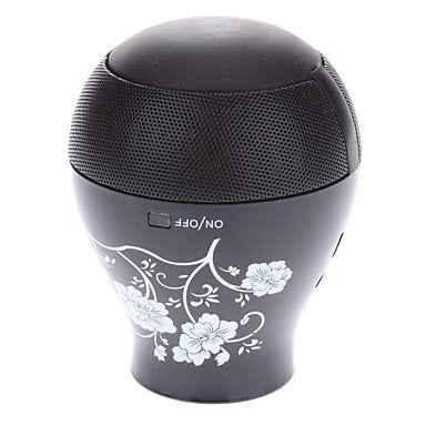 Black portable speaker with floral design and power button visible.