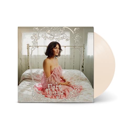 Woman in a pink dress sitting on a bed, framed by ornate white text.