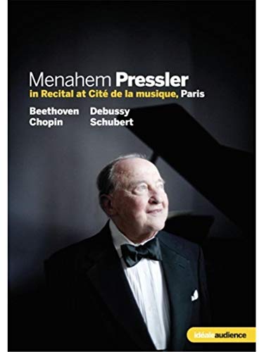 Menahem Pressler, a pianist in formal wear, with a piano in background.