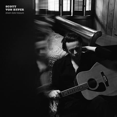 Black and white album cover featuring a man with a guitar.