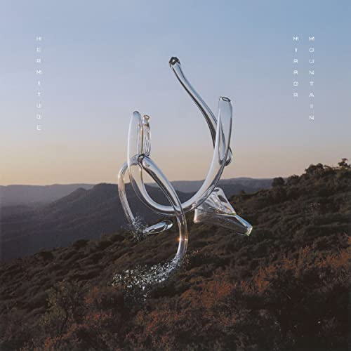 Album cover for Hermitude’s “Mirror Mountain” featuring a glass sculpture on a hillside.
