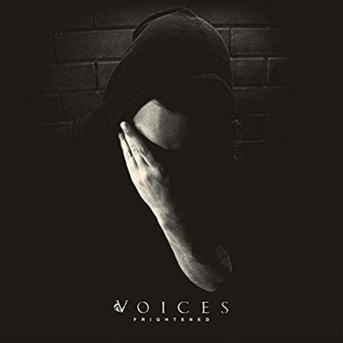 Hooded figure with hand to face, dark album cover for “Voices - Frightened.”