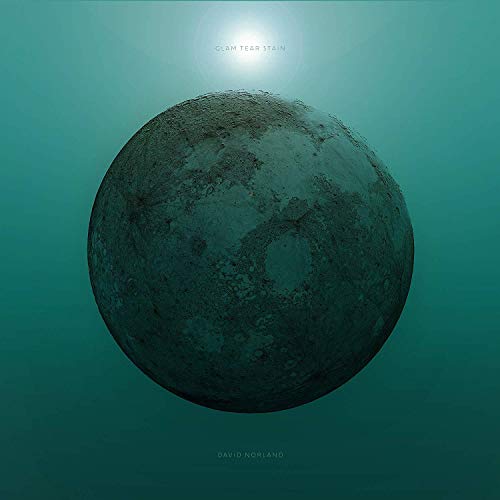 CD cover: textured dark sphere against a teal, blurred background.