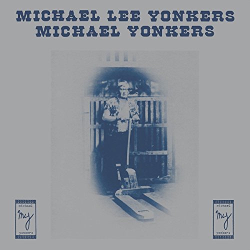 Vinyl record cover featuring a man with a long-handled tool in front of pallets.