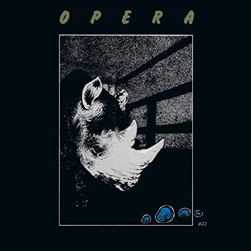 Vinyl record cover: black background with a rhinoceros portrait and blue dots.
