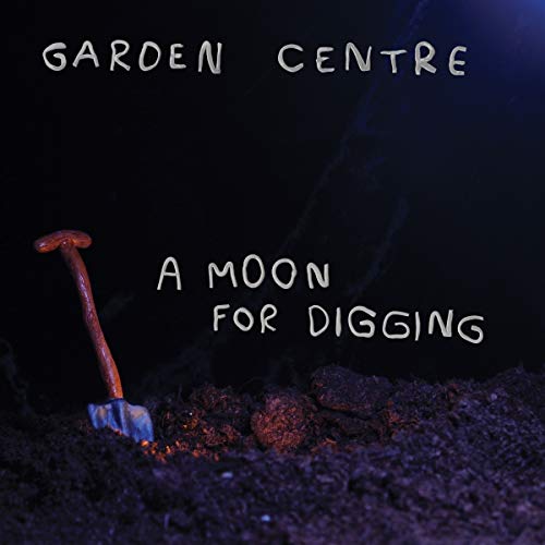 A shovel stands in dark soil against a black background with text overlay.