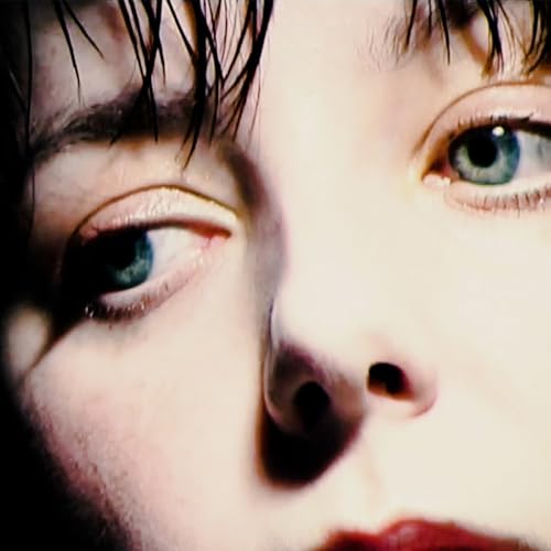 Close-up of a person’s eyes and nose, dark hair framing the face.