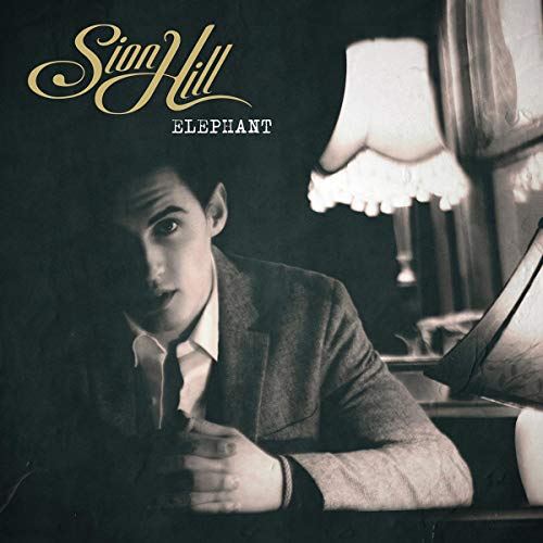 Vinyl album cover featuring a man in a suit, dimly lit room.