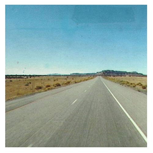 Highway receding into the distance under a clear blue sky.
