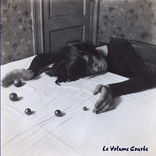 Black and white album cover with a person lying on a patterned surface.