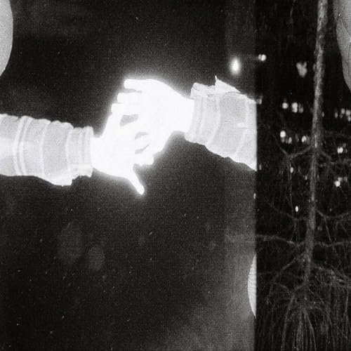 Black and white image of two hands reaching towards each other.