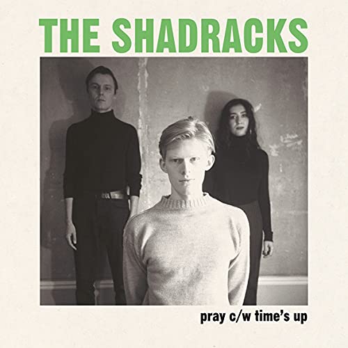Vinyl record cover featuring three people in dark clothing.